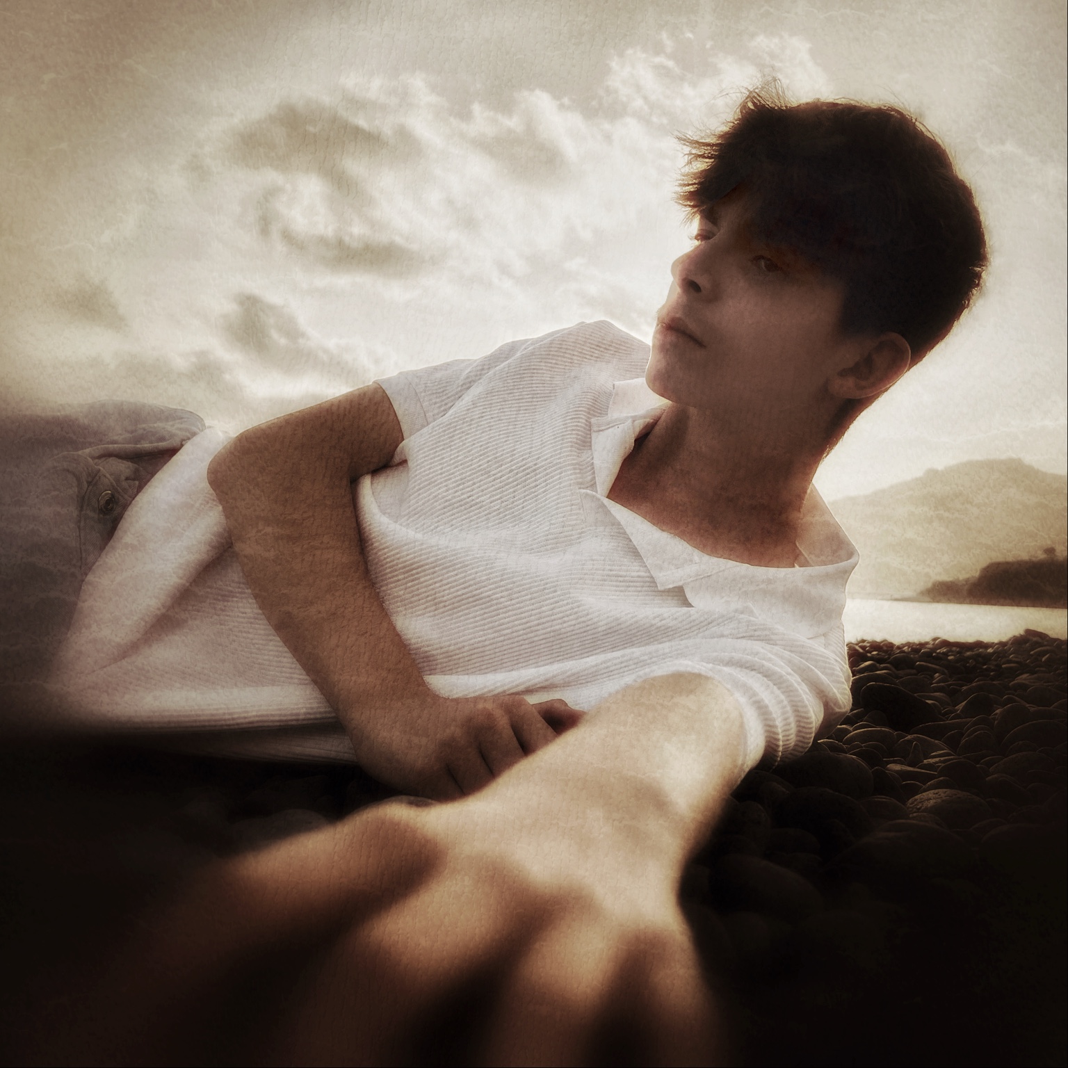 Dino Mateus Brown reclining on a beach in warm cinematic light