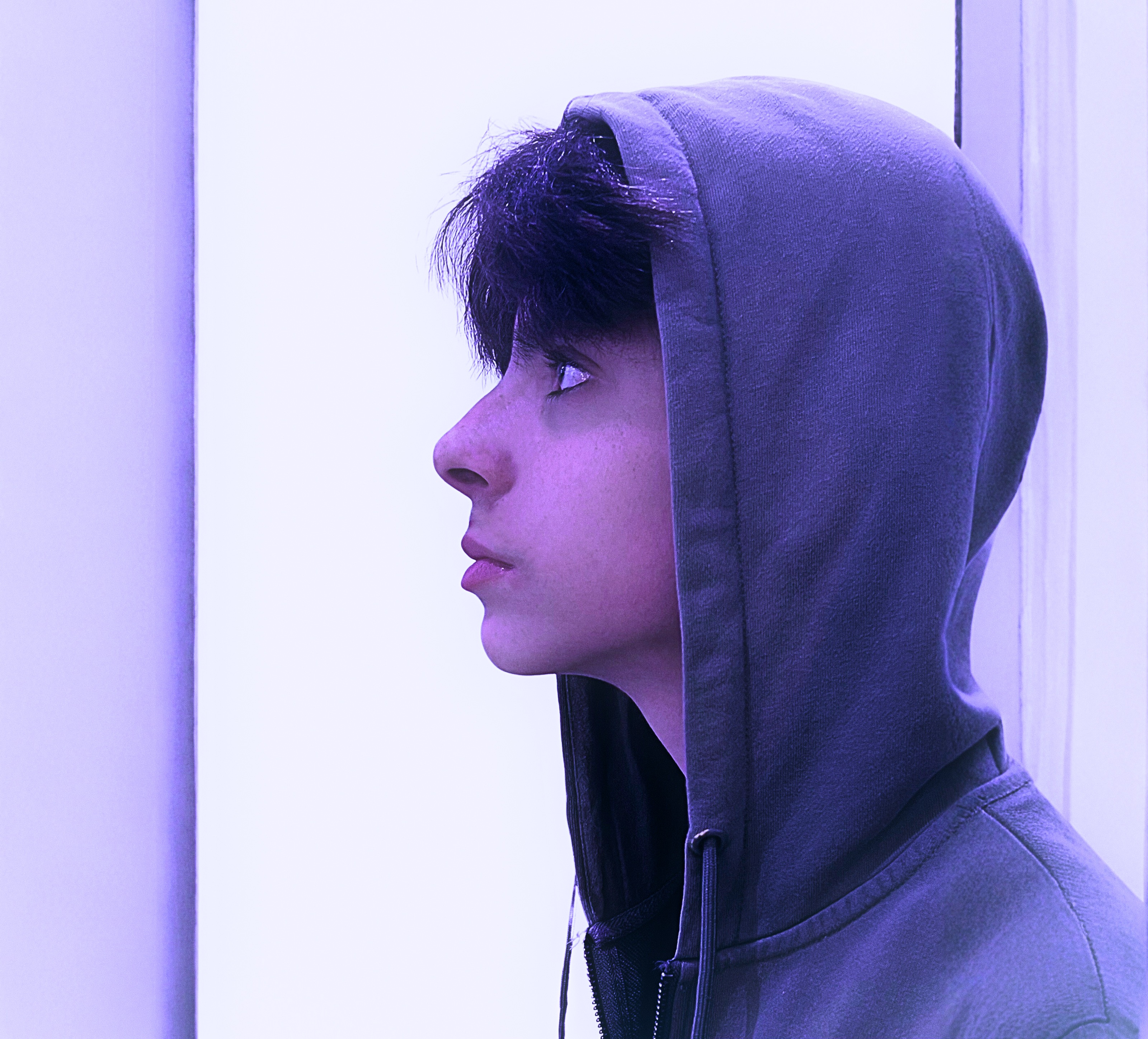 Dino Mateus Brown wearing a hood in violet light